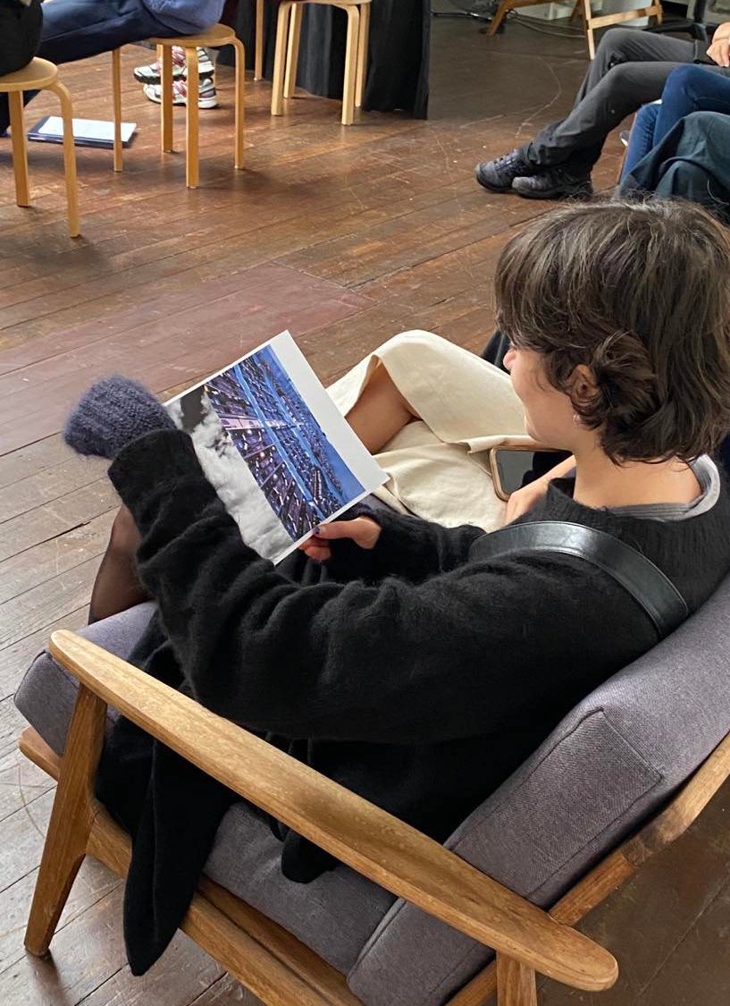 Someone sitting about to type on their phone, a shared google doc